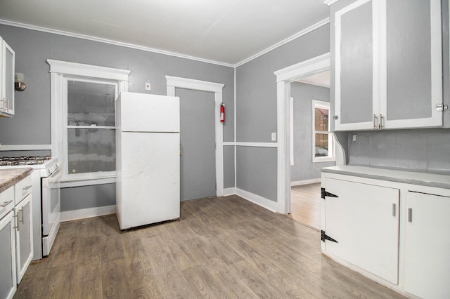 1850 S Burdick St, Kalamazoo, MI 49001 - kitchen with white appliances, ornamental molding, light wood-style floors, light countertops, and white cabinets