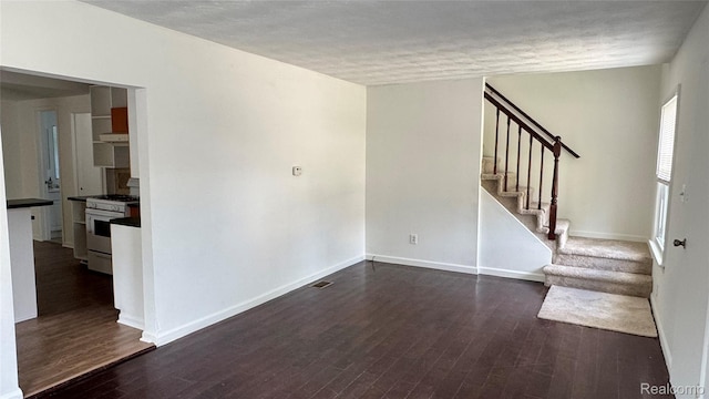 71 Cloveridge Dr, Troy, MI 48084 - unfurnished living room with stairs, dark wood-type flooring, and a textured ceiling