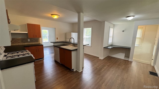 71 Cloveridge Dr, Troy, MI 48084 - kitchen with dark countertops, white appliances, dark wood-type flooring, exhaust hood, and backsplash