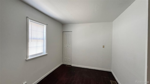 71 Cloveridge Dr, Troy, MI 48084 - unfurnished room with baseboards and dark wood finished floors