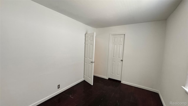 71 Cloveridge Dr, Troy, MI 48084 - spare room featuring dark wood-type flooring and baseboards