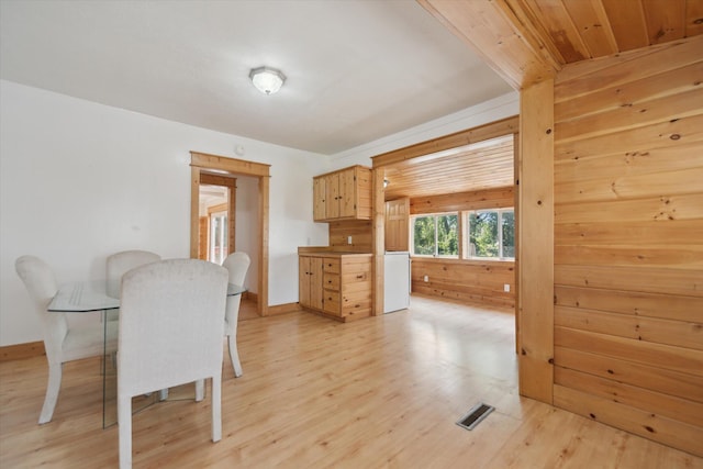 222 E Mill St, Hastings, MI 49058 - dining area with light wood finished floors and wood walls