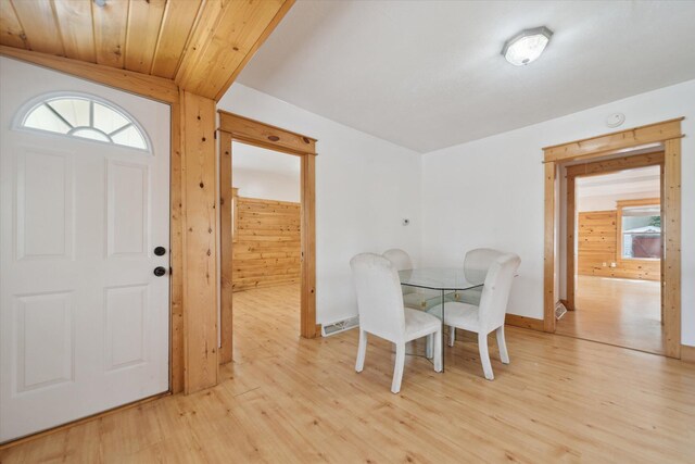 222 E Mill St, Hastings, MI 49058 - dining room with light wood finished floors and wooden walls