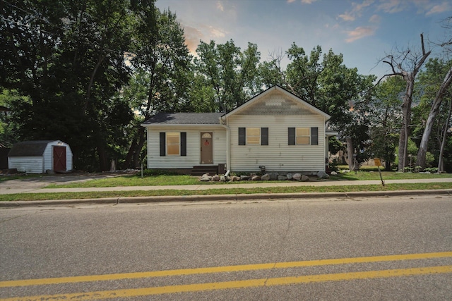 222 E Mill St, Hastings, MI 49058 - bungalow-style home with a storage unit, a front yard, and view of wooded area