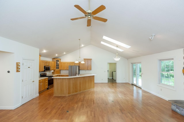 1803 Bell Rd, Niles, MI 49120 - kitchen with appliances with stainless steel finishes, light countertops, glass insert cabinets, a ceiling fan, and vaulted ceiling