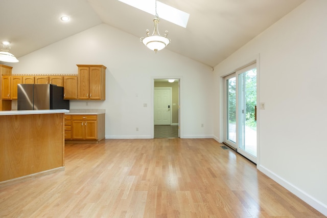 1803 Bell Rd, Niles, MI 49120 - kitchen featuring freestanding refrigerator, a skylight, light wood-type flooring, light countertops, and hanging light fixtures