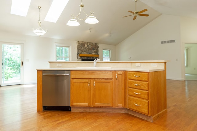 1803 Bell Rd, Niles, MI 49120 - kitchen featuring dishwasher, a stone fireplace, light wood-style flooring, light countertops, and high vaulted ceiling
