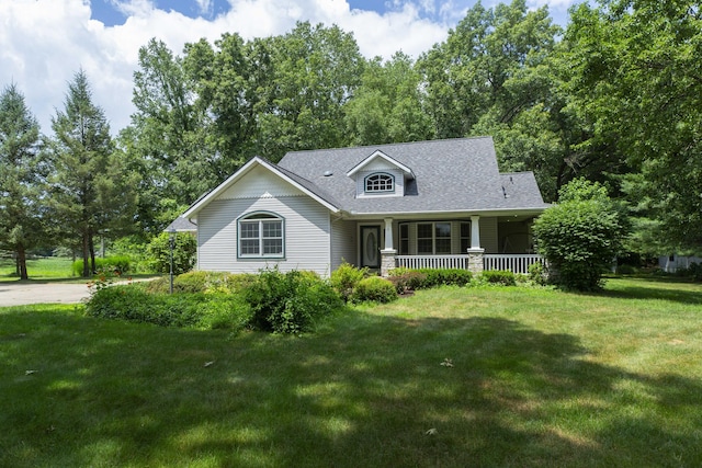1803 Bell Rd, Niles, MI 49120 - cape cod house with a porch, a front yard, and a shingled roof