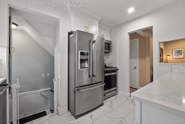 309 S Dorchester Ave, Royal Oak, MI 48067 - kitchen featuring appliances with stainless steel finishes, light marble finish floors, white cabinets, decorative backsplash, and a wainscoted wall