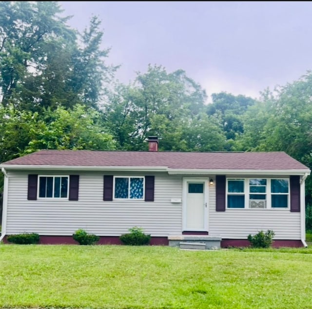 2032 Daron Pl, Flint, MI 48505 - ranch-style house featuring a chimney, a front yard, and a shingled roof