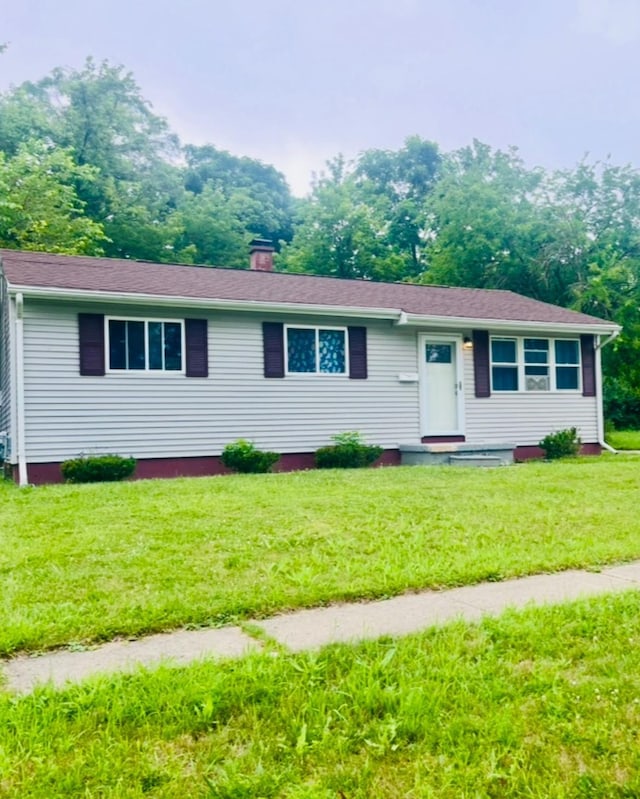 2032 Daron Pl, Flint, MI 48505 - ranch-style house with a front lawn and a chimney