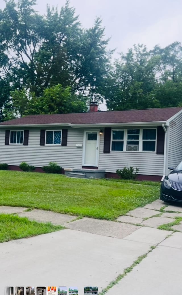 2032 Daron Pl, Flint, MI 48505 - ranch-style house featuring a chimney and a front lawn