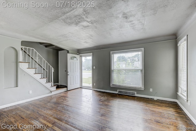 21797 Moross Rd, Grosse Pointe, MI 48236 - entrance foyer with wood finished floors, stairs, and a textured ceiling