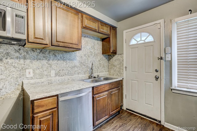 21797 Moross Rd, Grosse Pointe, MI 48236 - kitchen with dishwasher, dark wood-style floors, decorative backsplash, and brown cabinets