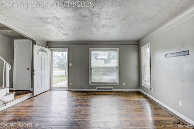 21797 Moross Rd, Grosse Pointe, MI 48236 - foyer featuring wood finished floors, stairway, and a textured ceiling