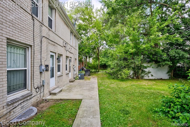 21797 Moross Rd, Grosse Pointe, MI 48236 - view of green lawn featuring a patio area