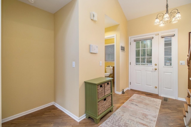 3542 Kirkaldy Cir, Portage, MI 49024 - foyer entrance featuring dark wood-style floors, a chandelier, and lofted ceiling
