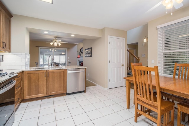 3542 Kirkaldy Cir, Portage, MI 49024 - kitchen featuring appliances with stainless steel finishes, ceiling fan, brown cabinets, a peninsula, and recessed lighting
