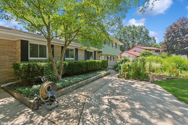 1320 S Manor Dr, Saint Joseph, MI 49085 - tri-level home featuring brick siding and a patio