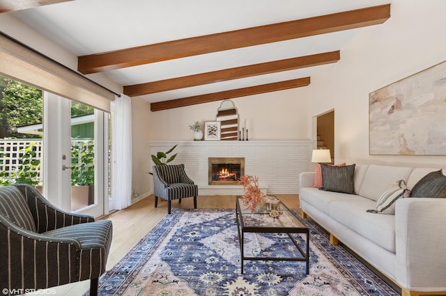 1320 S Manor Dr, Saint Joseph, MI 49085 - living room featuring beamed ceiling, wood finished floors, and a fireplace