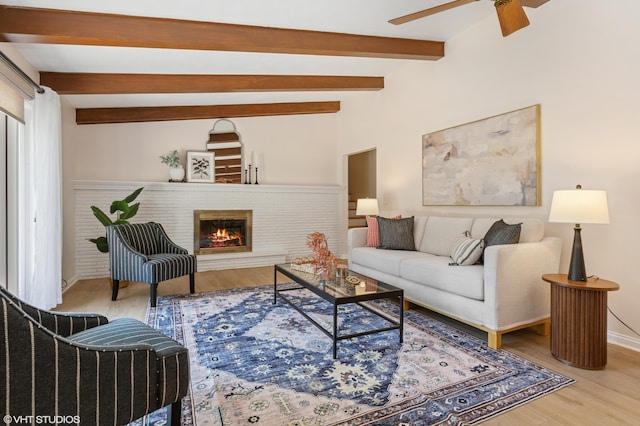 1320 S Manor Dr, Saint Joseph, MI 49085 - living area with wood finished floors, beamed ceiling, a ceiling fan, and a brick fireplace