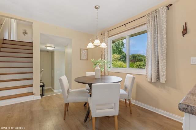 1320 S Manor Dr, Saint Joseph, MI 49085 - dining space featuring light wood-type flooring, stairway, and a chandelier