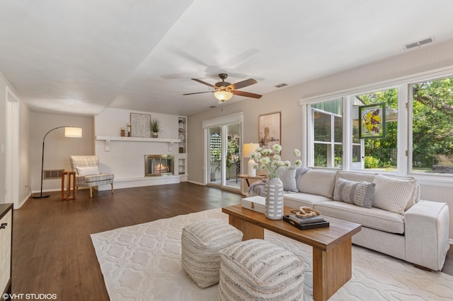 1320 S Manor Dr, Saint Joseph, MI 49085 - living room featuring wood finished floors, a ceiling fan, and a glass covered fireplace