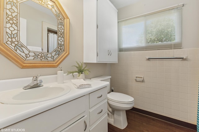 1320 S Manor Dr, Saint Joseph, MI 49085 - bathroom featuring tile walls, vanity, and wood finished floors