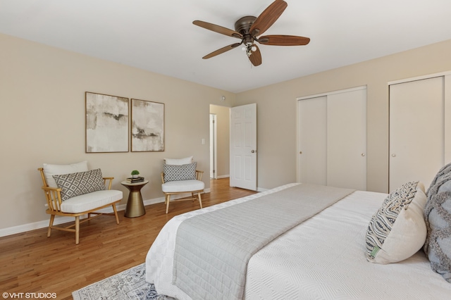 1320 S Manor Dr, Saint Joseph, MI 49085 - bedroom featuring light wood-style flooring, multiple closets, and a ceiling fan