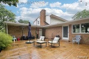 402 Thomas Ln, Grand Blanc, MI 48439 - back of house with a patio, a chimney, and outdoor lounge area