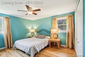 402 Thomas Ln, Grand Blanc, MI 48439 - bedroom featuring multiple windows, wood finished floors, and ceiling fan