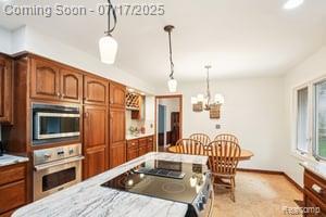 402 Thomas Ln, Grand Blanc, MI 48439 - kitchen with appliances with stainless steel finishes, light countertops, a chandelier, and decorative light fixtures