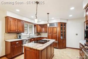 402 Thomas Ln, Grand Blanc, MI 48439 - kitchen with black electric stovetop, light countertops, recessed lighting, brown cabinets, and a kitchen island
