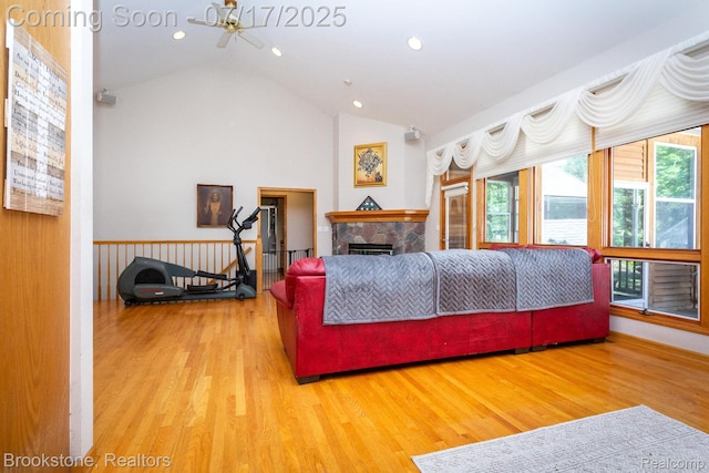 8808 Big Lake Rd, Clarkston, MI 48346 - living room with ceiling fan, wood finished floors, recessed lighting, a fireplace, and high vaulted ceiling