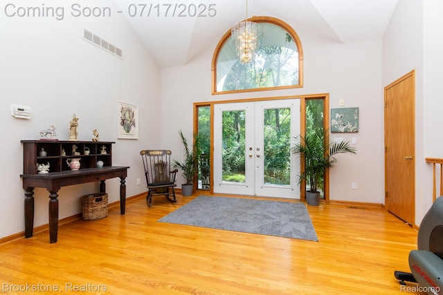 8808 Big Lake Rd, Clarkston, MI 48346 - entrance foyer with high vaulted ceiling, a chandelier, wood finished floors, and french doors