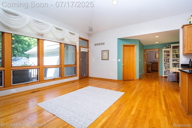 8808 Big Lake Rd, Clarkston, MI 48346 - unfurnished living room with light wood-type flooring