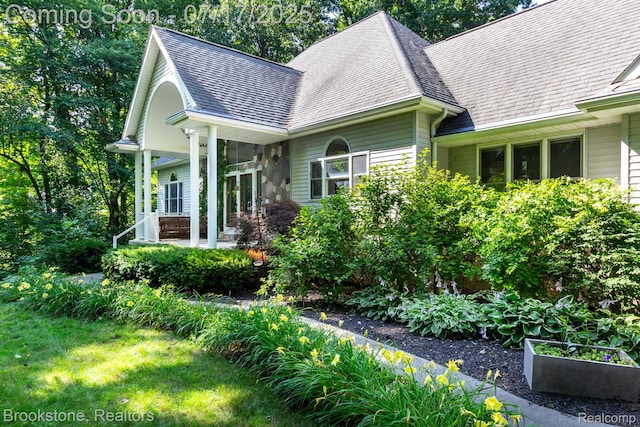 8808 Big Lake Rd, Clarkston, MI 48346 - view of side of home with roof with shingles and a garden
