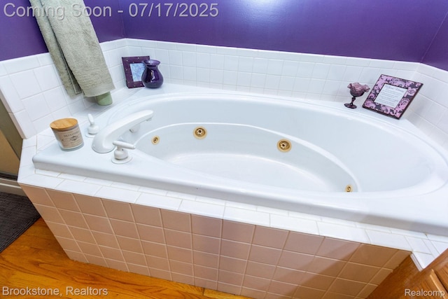 8808 Big Lake Rd, Clarkston, MI 48346 - full bath featuring a whirlpool tub and wood finished floors