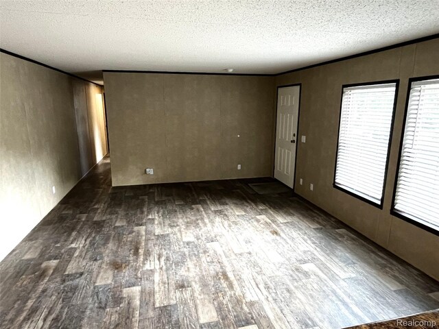 8499 LOT214 E M 71, Durand, MI 48429 - empty room featuring wood finished floors and a textured ceiling