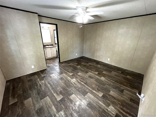 8499 LOT214 E M 71, Durand, MI 48429 - spare room with dark wood-type flooring, ceiling fan, a textured ceiling, and crown molding
