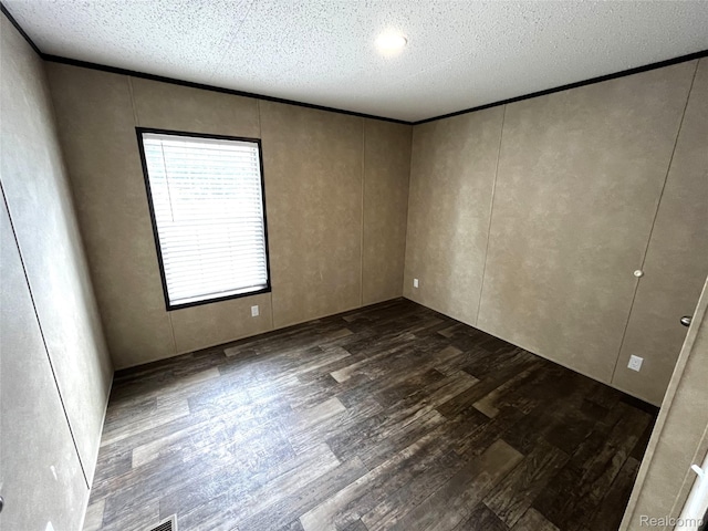 8499 LOT214 E M 71, Durand, MI 48429 - spare room featuring dark wood-style flooring and a textured ceiling