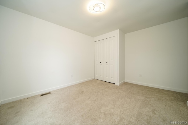 45293 Heatherwoode Ln, Macomb, MI 48044 - unfurnished bedroom featuring light colored carpet and a closet