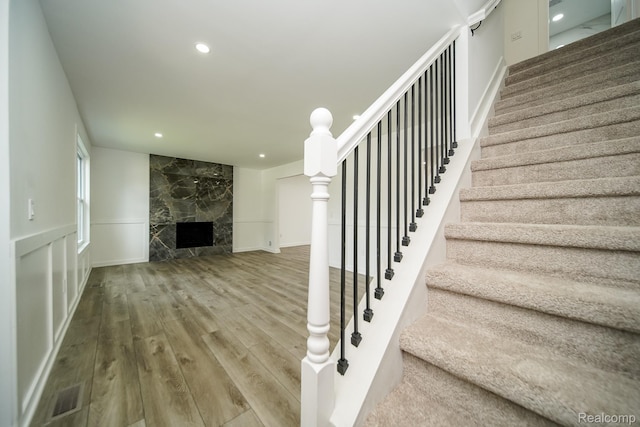 45293 Heatherwoode Ln, Macomb, MI 48044 - stairway featuring wood finished floors, recessed lighting, and a high end fireplace
