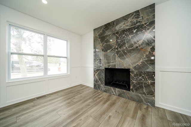 45293 Heatherwoode Ln, Macomb, MI 48044 - unfurnished living room with wood finished floors and a large fireplace