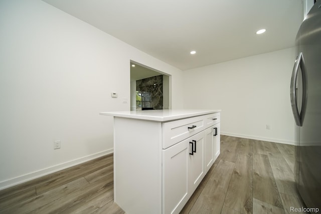 45293 Heatherwoode Ln, Macomb, MI 48044 - kitchen featuring freestanding refrigerator, light wood-type flooring, white cabinetry, light countertops, and recessed lighting