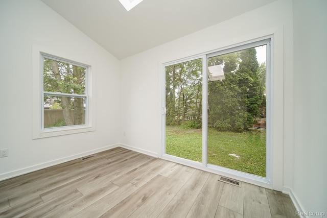 45293 Heatherwoode Ln, Macomb, MI 48044 - empty room featuring wood finished floors, vaulted ceiling, and a skylight