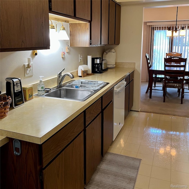 44736 Lynn Dr, Plymouth, MI 48170 - kitchen featuring light countertops, a chandelier, light tile patterned flooring, dishwasher, and light carpet