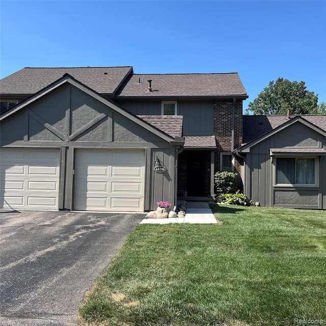 44736 Lynn Dr, Plymouth, MI 48170 - view of front of home with a garage, driveway, a front lawn, a shingled roof, and board and batten siding
