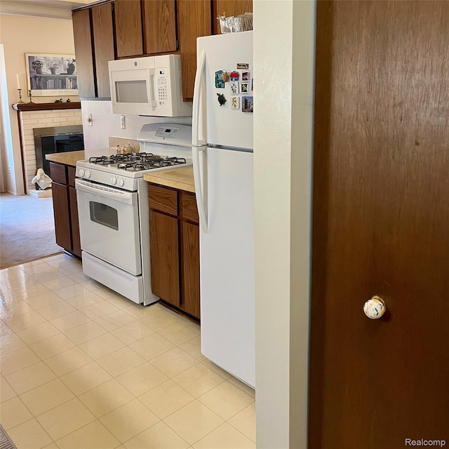 44736 Lynn Dr, Plymouth, MI 48170 - kitchen with white appliances, light countertops, a fireplace, and light carpet