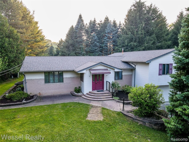 2465 Texter Rd, Leonard, MI 48367 - view of front of house featuring a front yard, a shingled roof, and brick siding